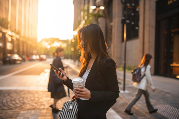 Woman distracted looking at phone worried she is wasting time if she isn't always busy