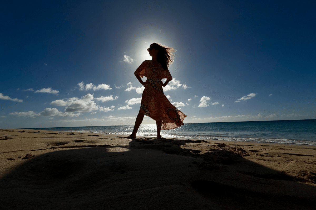 Silhouette of Katarina Stoltz on the beach as sunset as she asked if there anything really wrong with being a high-achiever?