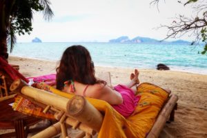 Katarina Stoltz Life Coach reading and relaxing on a beach in Thailand