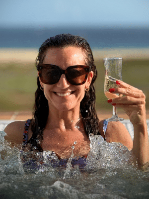 Life coach Katarina Stoltz celebrating success in a hot tub drinking champagne