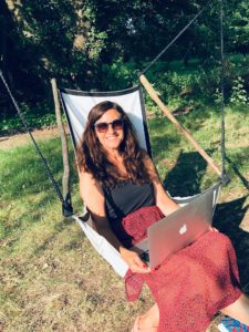 Katarina Stoltz Coaching and Therapy on laptop in garden