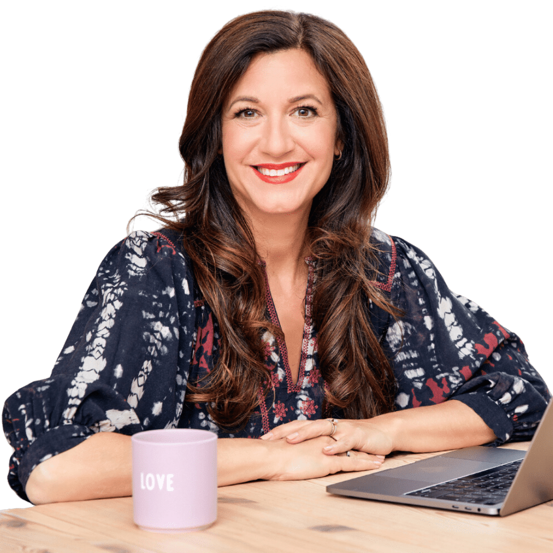 Life Coach Katarina Stoltz smiling at desk with laptop. Download her Career Clarity Roadmap.