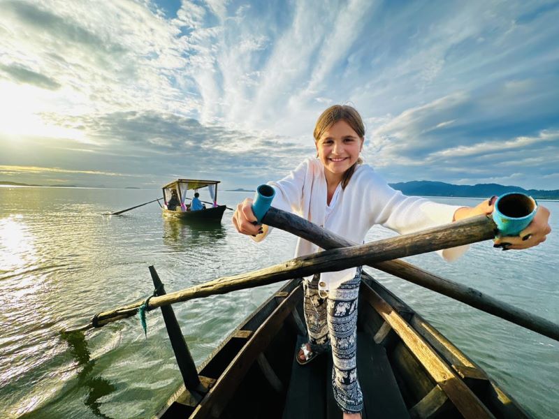 Katarina's daughter rowing a gondola boat in Thailand