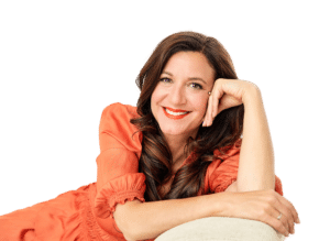 Life coach Katarina Stoltz in an orange dress on sofa