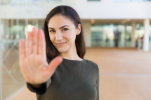 Image of woman with hand in stop gesture to demonstrate how to set healthy boundaries with Katarina Stoltz
