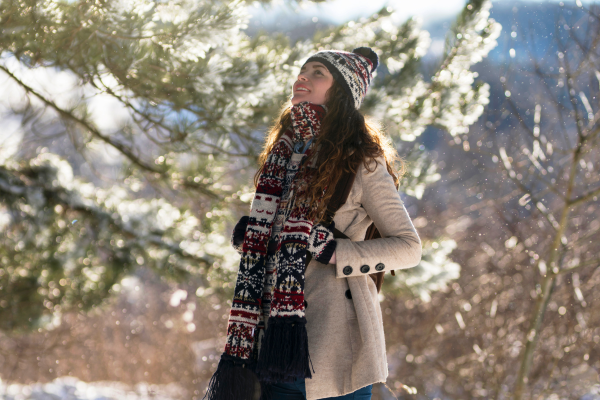 Woman dressed warmly taking a winter walk enjoying a stress free Christmas